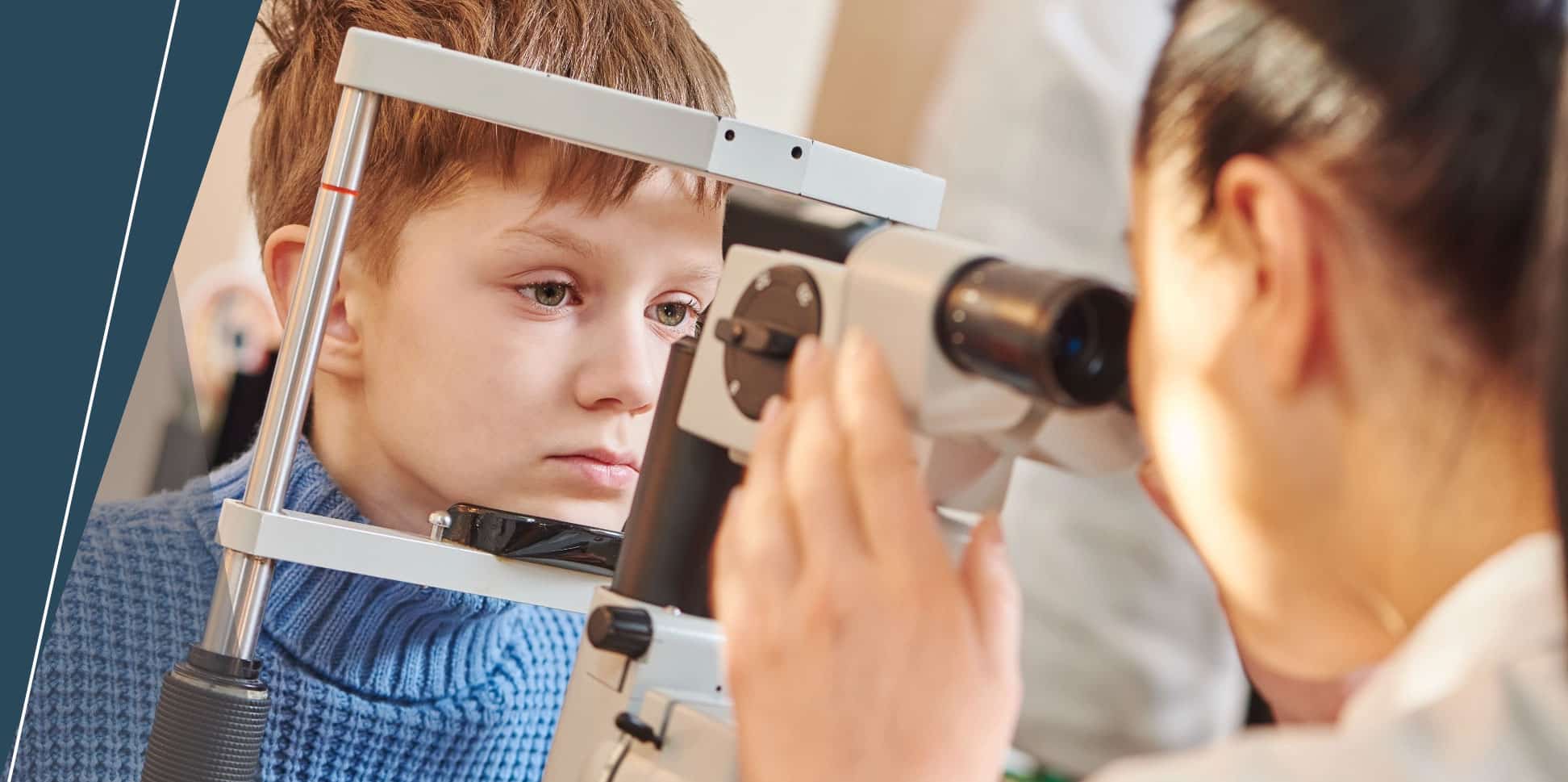 young boy having eyes examined at optometrist