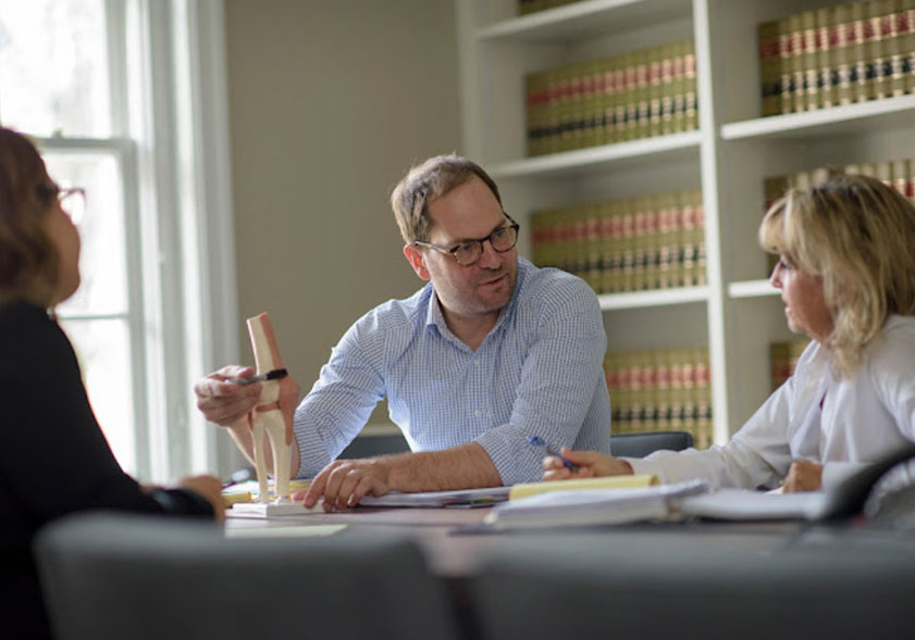 Attorneys Mark Atlee and Robin Jabour sitting at table discussing the details of a case